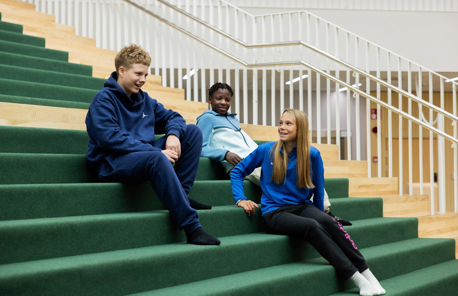 Kolme nuorta Etelä-Nummelan koulukeskuksen portailla